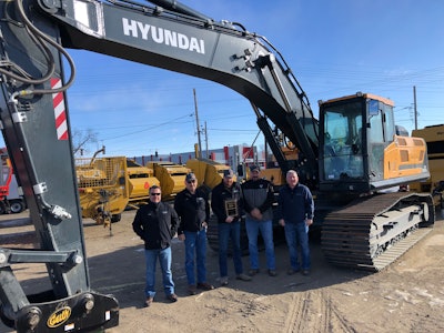 West River Equipment management team stands in front of Hyundai excavator