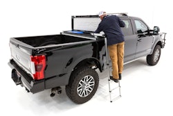 Man uses optional ladder to see into his Decked tool box in the back of a truck.