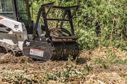 Bobcat loader drum mulched clearing brush.