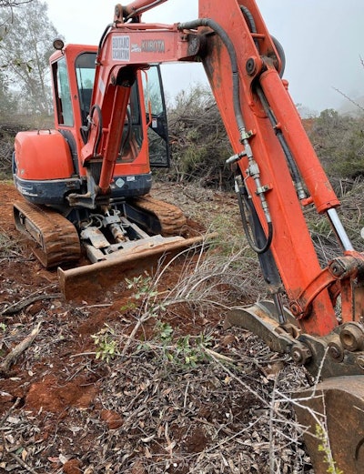 Boitano Excavation Kubota excavator clearing brush.