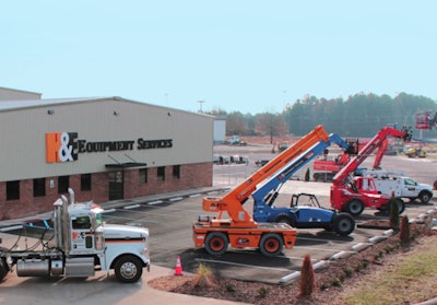 H&E Equipment Services yard with telehandlers parked outside