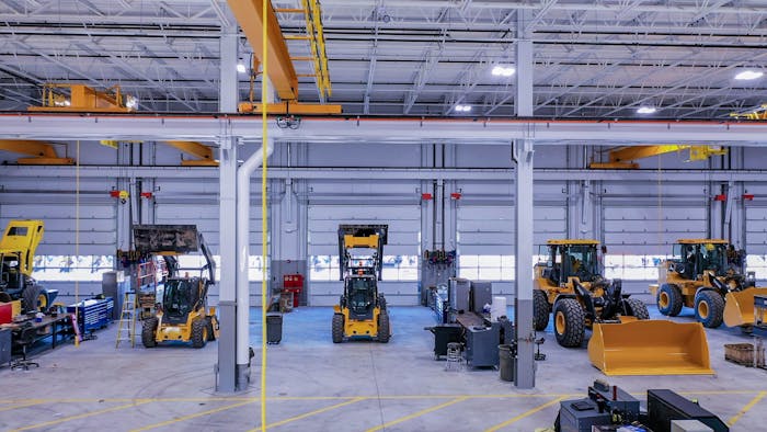 West Side Tractor shop with heavy and compact construction equipment in need of maintenance.