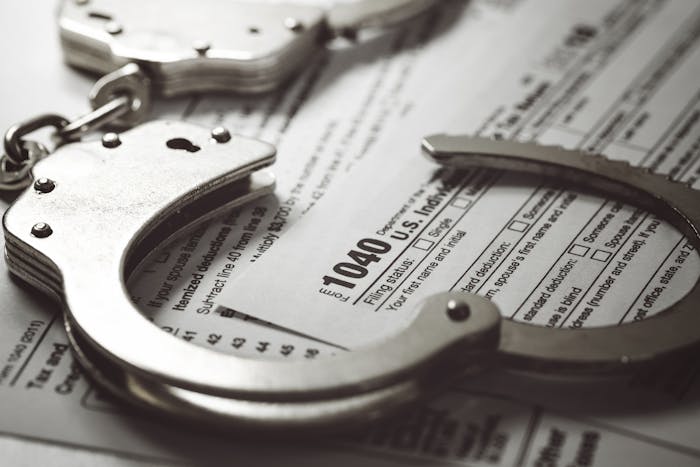 handcuffs sitting on a 1040 tax form