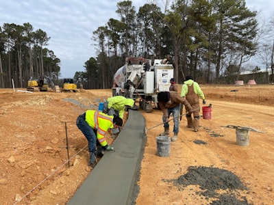 H.W. Tucker concrete crew installing curbs in a new subdivision.