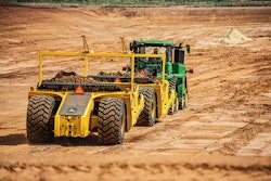 John Deere tractor pulling towed scraper.
