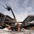 JLG Rotating Telehandler at a commercial construction site.