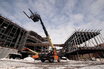 JLG Rotating Telehandler at a commercial construction site.