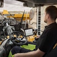Volvo wheel loader operator in cab using app tablet