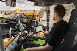 Volvo wheel loader operator in cab using app tablet