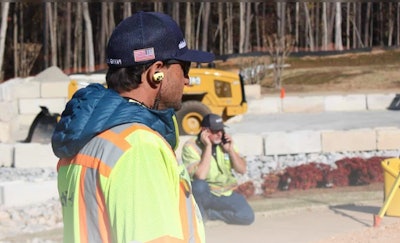 Construction worker wearing Clear 360 Pro earbuds