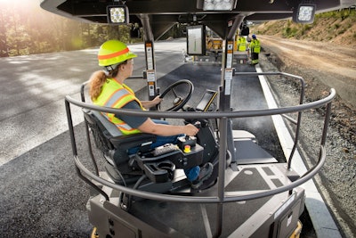 Volvo asphalt compactor behind paver