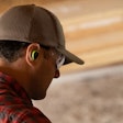 A customer wearing ISOtunes Free Aware earbuds