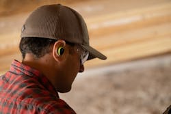 A customer wearing ISOtunes Free Aware earbuds