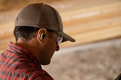 A customer wearing ISOtunes Free Aware earbuds