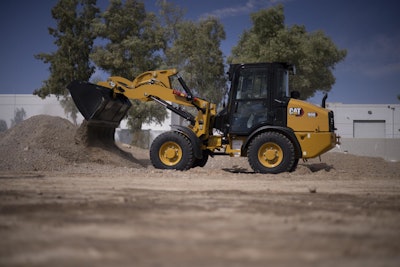 Cat new 906 compact wheel loader dumping dirt
