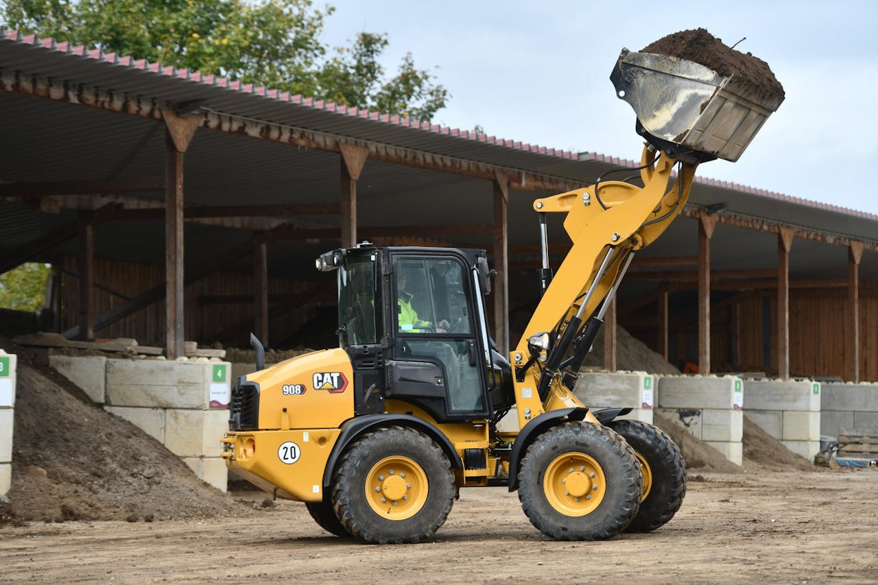 Cat 908 high-lift compact wheel loader with full bucket