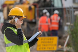 Female construction worker using a tablet on a jobsite