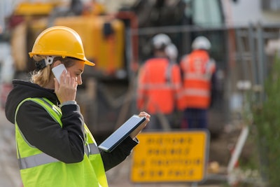 Female construction worker using a tablet on a jobsite