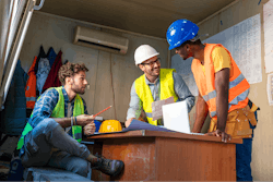 Construction management team discussing payroll.