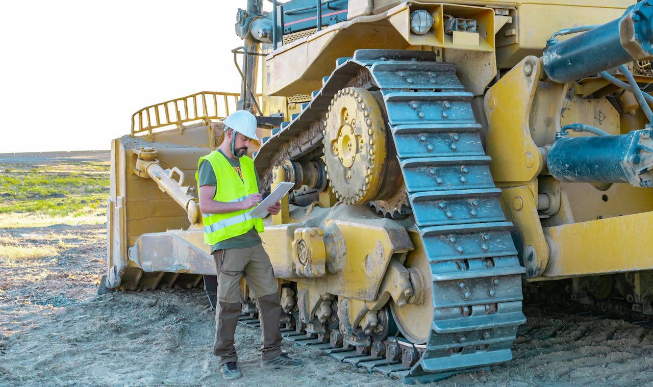 Worker checking out dozer.