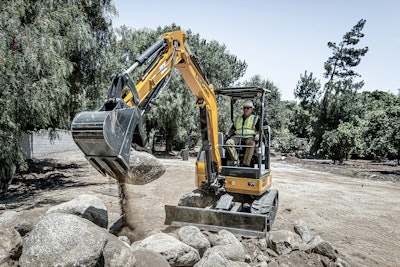 LiuGong mini excavator with thumb attachment picking up a rock