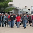 Members of UAW Local 180 walk out of the CNH Industrial plant