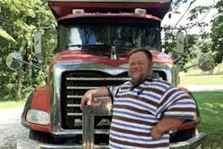William 'Porkchop' poses with Mack dump truck