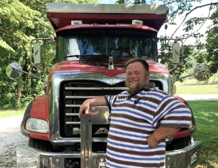 William 'Porkchop' poses with Mack dump truck
