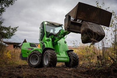 Avant Tecno new 650i compact wheel loader holding rock