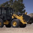 Cat wheel loader hauling load of gravel