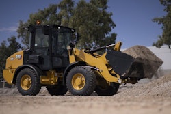 Cat wheel loader hauling load of gravel