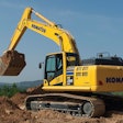 Komatsu PC290 Excavator scoops a bucket of dirt