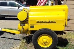 yellow restored 1943 Ingersoll-Rand-air-compressor parked by house