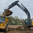 Deere 470G Excavator with Werk-Brau bucket loading a Volvo haul truck