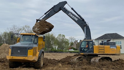 Deere 470G Excavator with Werk-Brau bucket loading a Volvo haul truck