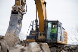 Cat excavator pulverizing rocks