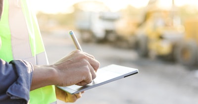 Man using a tablet at a construction site