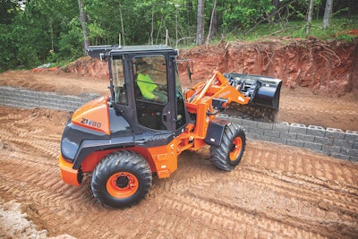 Hitachi ZW80T4F compact wheel loader placing dirt for concrete block foundation