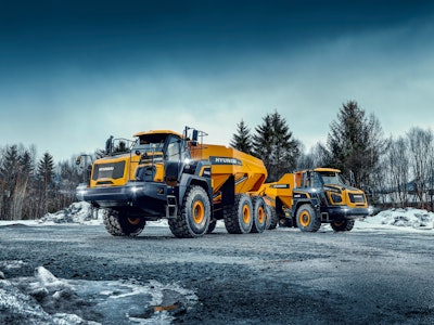 Hyundai new HA30 and HA45 articulated dump trucks on gravel road in snow