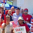 U.S. Sen. Bernie Sanders posing with stickers in Racine