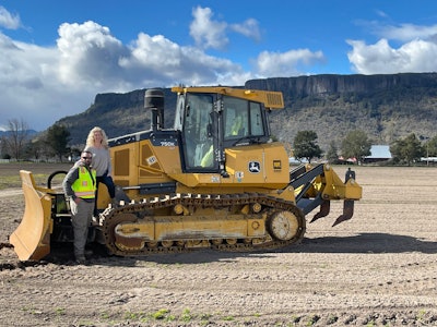 Alyson and Jeff Fowler, owners of Pilot Rock Excavation by a dozer