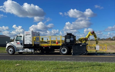 SealMaster CrackPro robotic seal coat truck-mounted system side view on asphalt highway