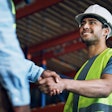 Construction workers shaking hands