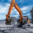 Hitachi excavator scoops a bucket of dirt