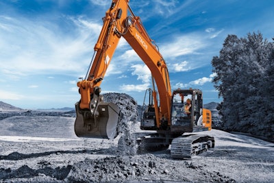 Hitachi excavator scoops a bucket of dirt