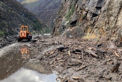 mudslide Highway 70 Northern California wheeled loader clears mud debris in Feather River Canyon