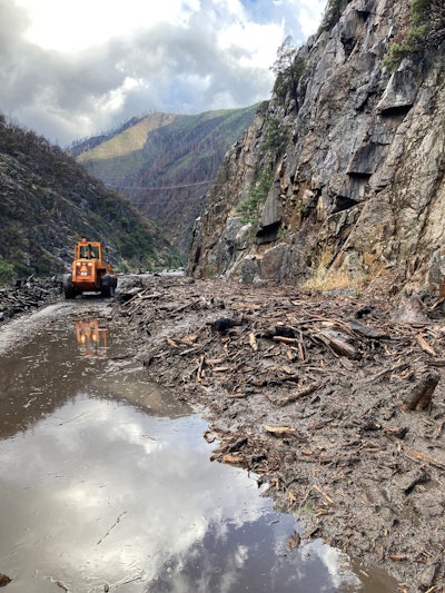 mudslide Highway 70 Northern California wheeled loader clears mud debris in Feather River Canyon