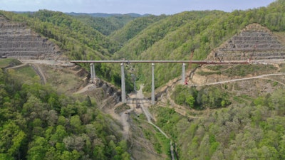 aerial view of 324-foot-high Pond Creek Bridge in Pike County Kentucky between rough hills over creek