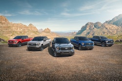 Six 2023 Ford F-150 Heritage Edition of various colors arranged in a row in desert