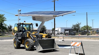 Volvo Wheel Loader charging under a Beam Global EV Arc solar charging system